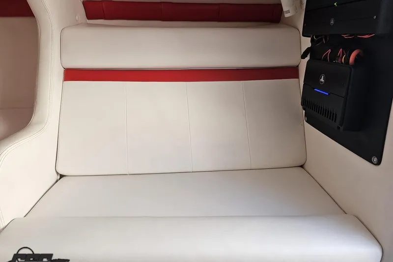 Slide: The Image of 2008 Donzi 27 ZR interior with white and red seating, featuring modern audio equipment. - 81