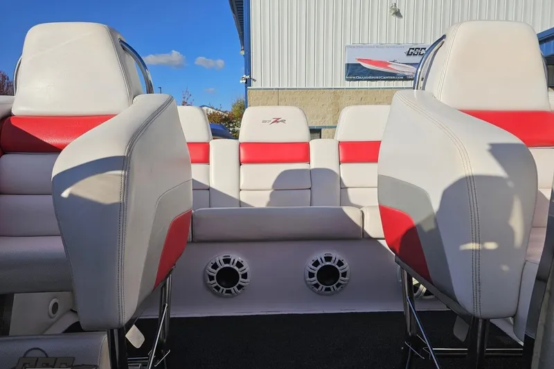 Slide: The Image of 2008 Donzi 27 ZR boat interior with red and white seating, featuring speakers. - 88