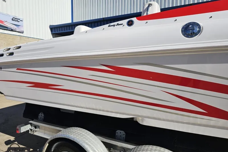 Slide: The Image of 2008 Donzi 27 ZR boat with red and gray graphics on a trailer. - 9