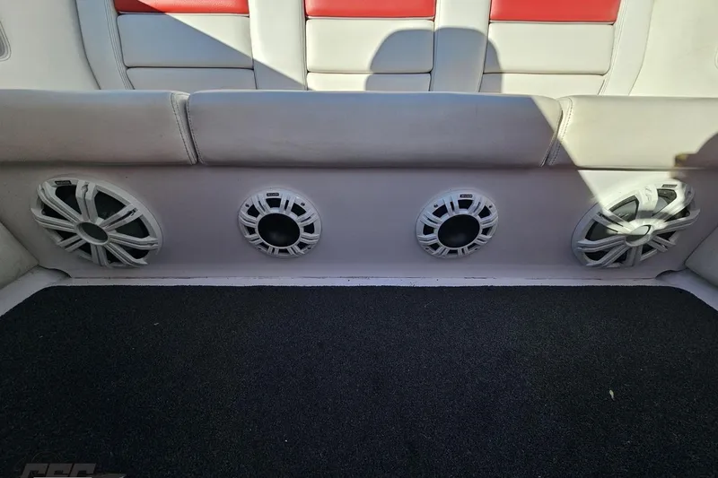 Slide: The Image of Interior of 2008 Donzi 27 ZR boat with built-in speakers and cushioned seating. - 95