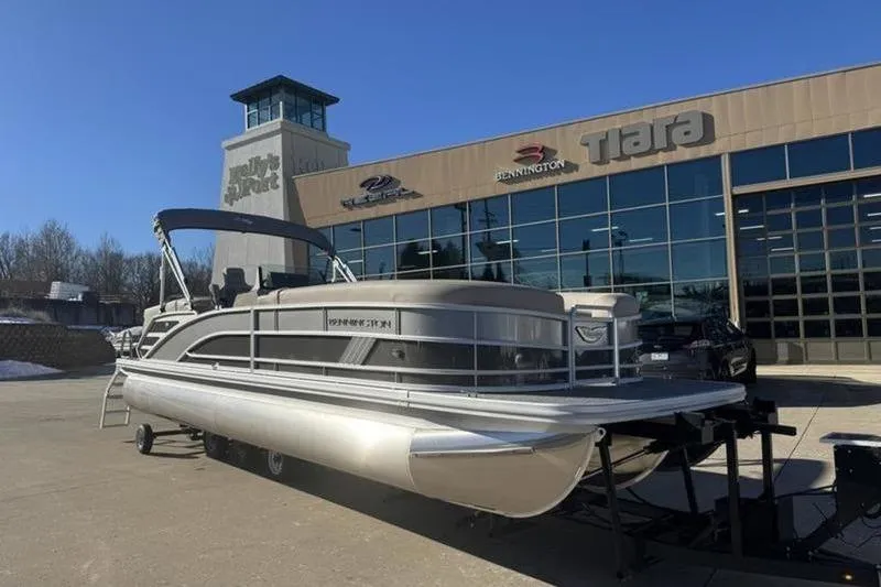 The Image of 2025 Bennington 26 MFB-SPS pontoon boat displayed outside dealership. - 1