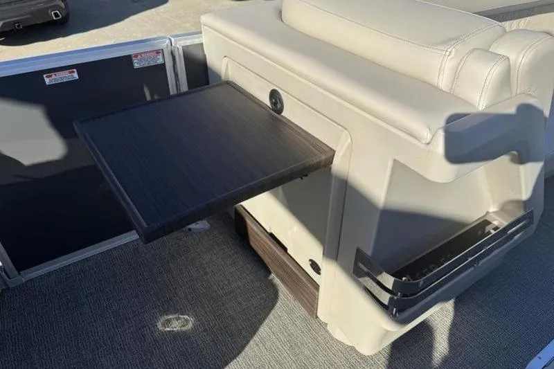 Slide: The Image of 2025 Bennington 26 MFB-SPS boat interior with fold-out table and seating. - 13