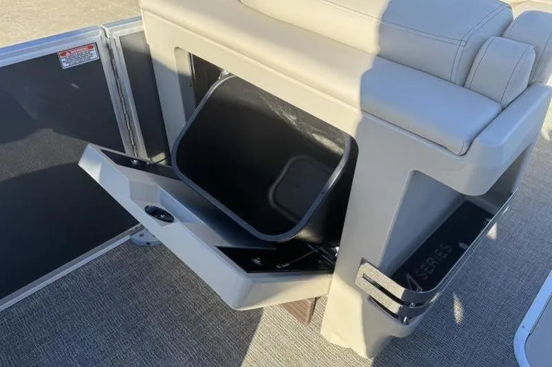 Slide: The Image of 2025 Bennington 26 MFB-SPS boat seat with integrated storage compartment open. - 14