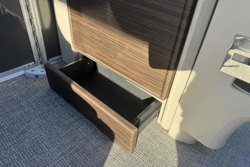 Slide: The Image of Open storage drawer in 2025 Bennington 26 MFB-SPS boat interior. - 15