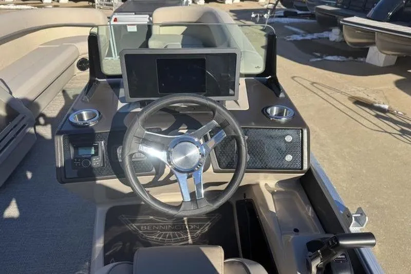 Slide: The Image of 2025 Bennington 26 MFB-SPS boat dashboard with steering wheel and digital display. - 19
