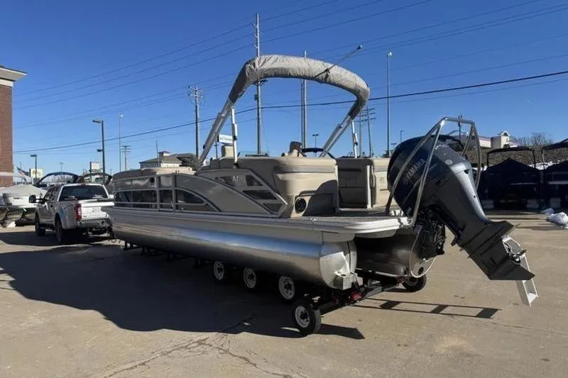 Slide: The Image of 2025 Bennington 26 MFB-SPS pontoon boat on trailer, parked outdoors. - 23