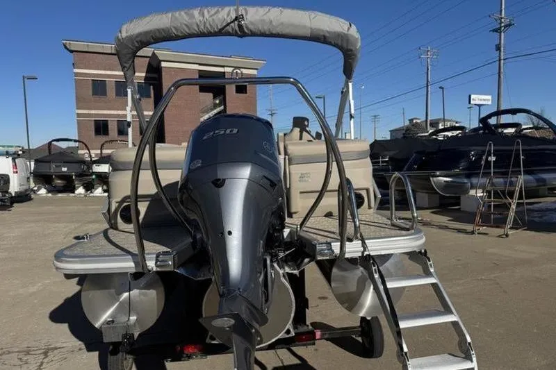 Slide: The Image of 2025 Bennington 26 MFB-SPS pontoon boat with outboard motor and ladder. - 24
