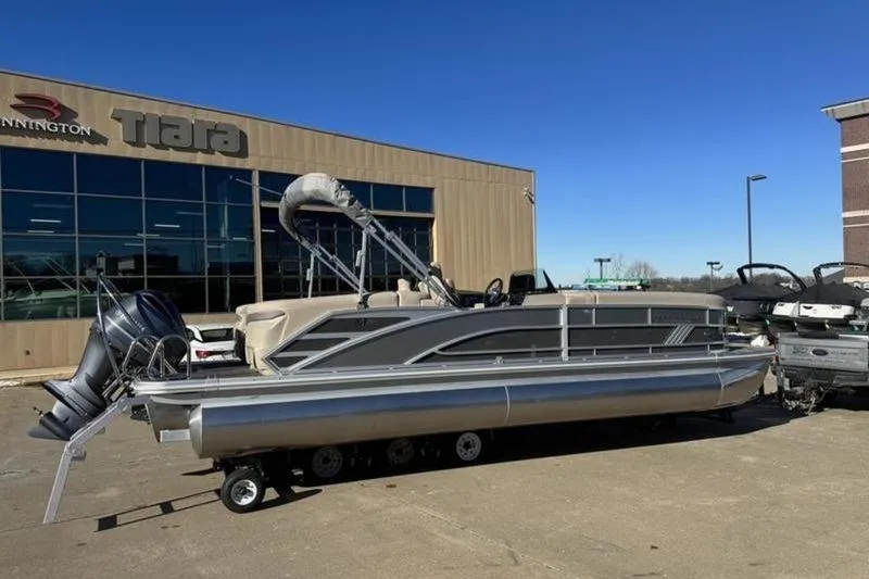 Slide: The Image of 2025 Bennington 26 MFB-SPS pontoon boat parked outside dealership. - 3