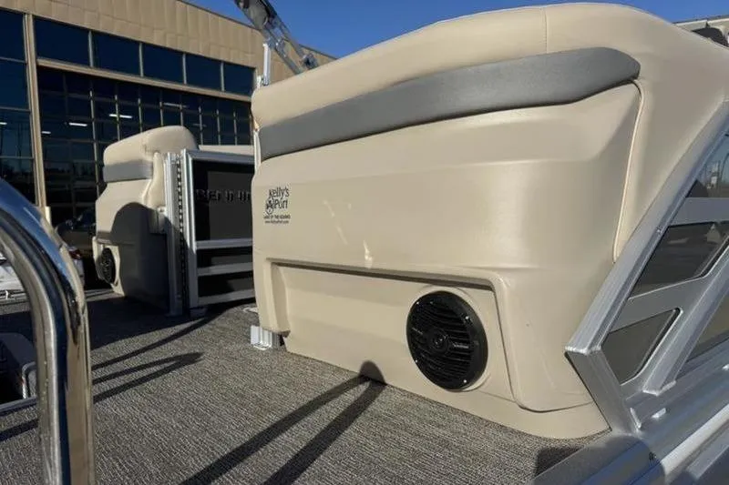 Slide: The Image of 2025 Bennington 26 MFB-SPS pontoon boat interior with beige seating and speaker. - 6