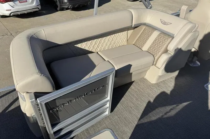 Slide: The Image of 2025 Bennington 26 MFB-SPS boat interior with beige seating and diamond-patterned upholstery. - 7