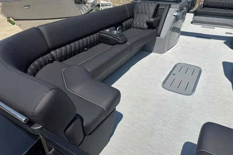 Slide: The Image of Luxurious seating on 2026 Bennington 30 QSBAX boat, featuring sleek black upholstery. - 16