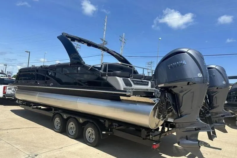 Slide: The Image of 2026 Bennington 30 QSBAX pontoon boat with dual Yamaha outboard motors on a trailer. - 19
