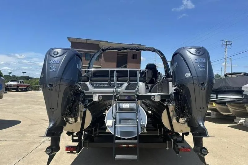 Slide: The Image of 2026 Bennington 30 QSBAX boat with dual outboard engines, parked outdoors. - 20