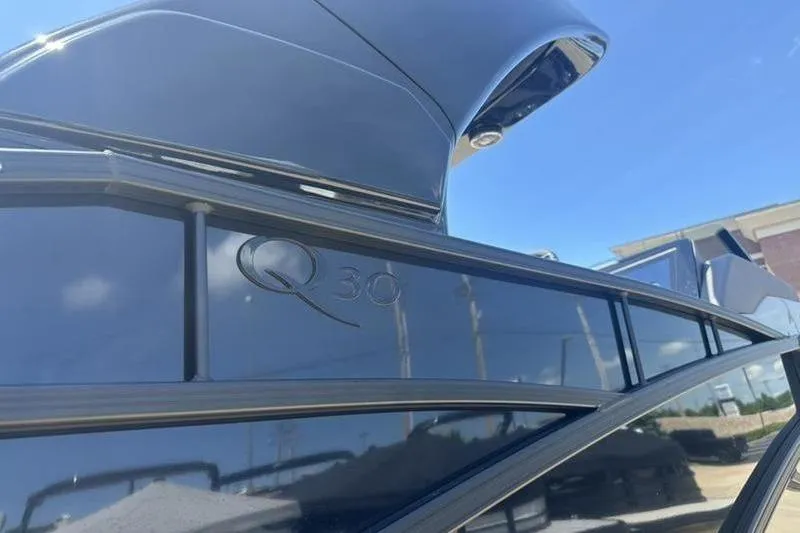 Slide: The Image of 2026 Bennington 30 QSBAX boat exterior with sleek design and Q30 logo. - 4
