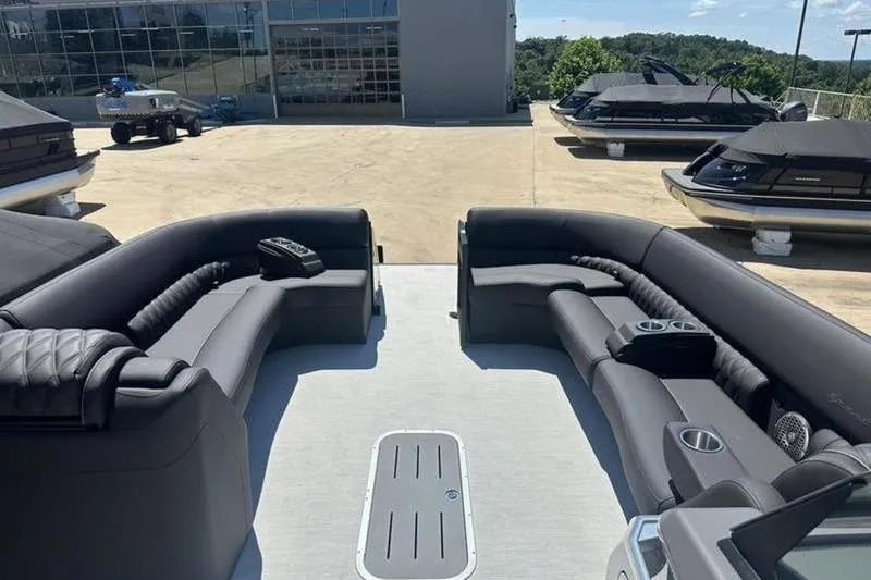 Slide: The Image of 2026 Bennington 30 QSBAX pontoon boat interior with luxurious seating and cup holders. - 5