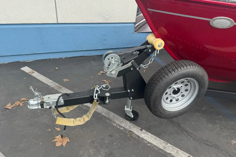 Slide: The Image of Trailer hitch of a 2021 Lund 1650 Angler SS boat in a parking lot. - 5