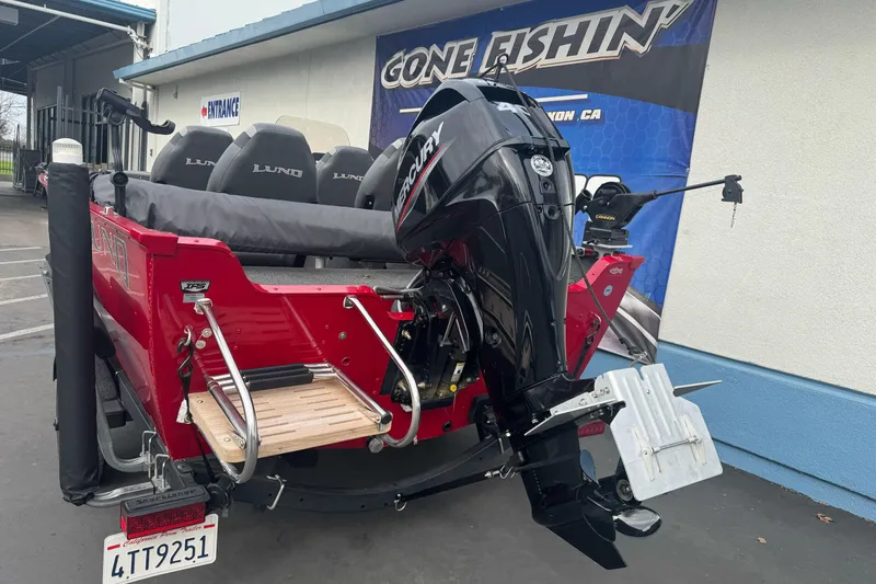 Slide: The Image of 2021 Lund 1650 Angler SS boat with Mercury outboard motor, parked at dealership. - 7