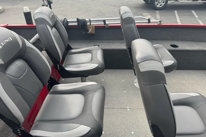 Slide: The Image of 2021 Lund 1650 Angler SS boat interior with gray seating and red accents. - 9