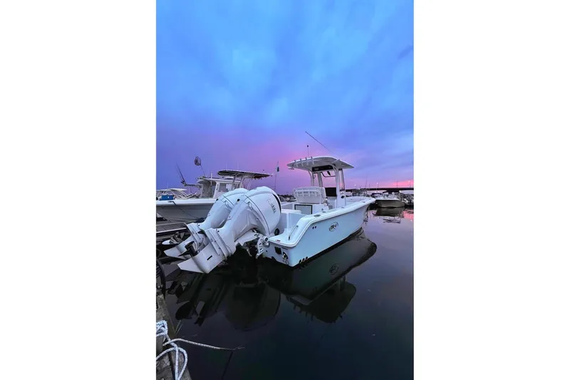 The Image of 2024 Sea Hunt Gamefish 25 boat docked at sunset with dual Yamaha engines. - 0