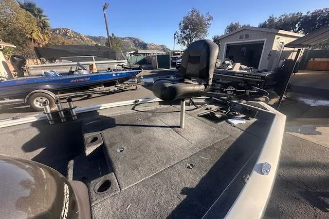 Slide: The Image of 2022 Tracker Pro Team 175 TXW fishing boat with seating, parked outdoors. - 3