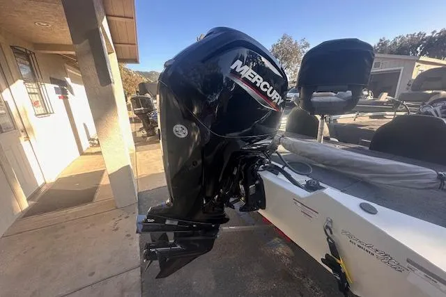Slide: The Image of 2022 Tracker Pro Team 175 TXW boat with Mercury outboard motor, parked outdoors. - 6