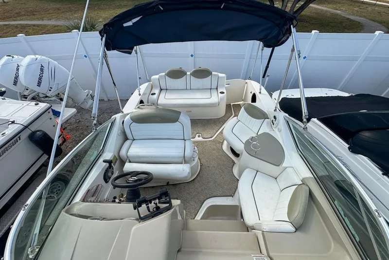 Slide: The Image of 2007 Sea Ray 240 Sundancer boat interior with seating and steering wheel. - 101
