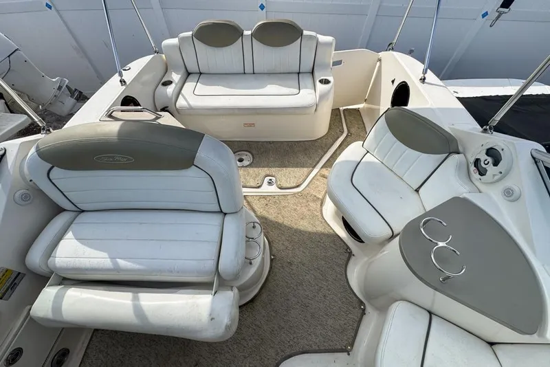Slide: The Image of 2007 Sea Ray 240 Sundancer boat interior with white seating and cup holders. - 102