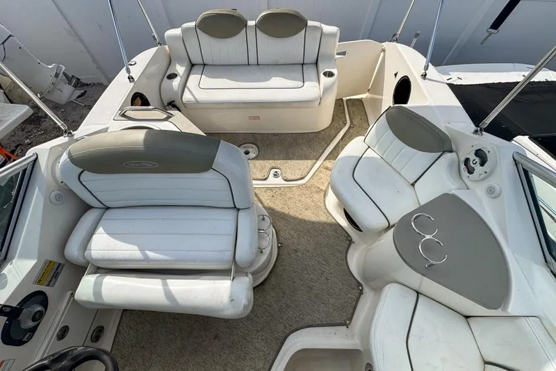 Slide: The Image of 2007 Sea Ray 240 Sundancer boat interior with white seating and carpeted floor. - 103