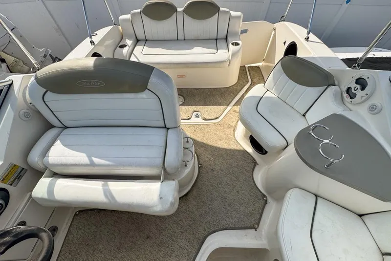 Slide: The Image of 2007 Sea Ray 240 Sundancer boat interior with white seating and cup holders. - 104