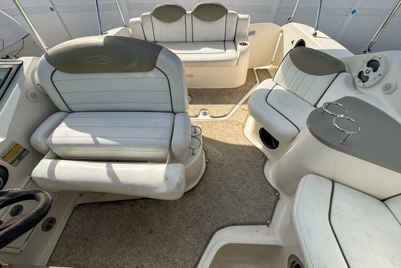 Slide: The Image of Interior of a 2007 Sea Ray 240 Sundancer boat with white seating and carpeted floor. - 105