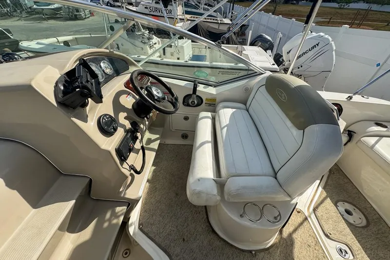Slide: The Image of 2007 Sea Ray 240 Sundancer boat interior with helm and seating area. - 106