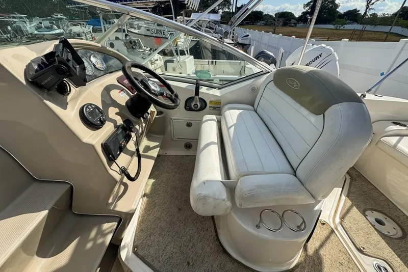 Slide: The Image of 2007 Sea Ray 240 Sundancer boat interior with steering wheel and seating area. - 107