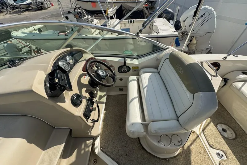 Slide: The Image of 2007 Sea Ray 240 Sundancer boat interior with steering wheel and seating area. - 108