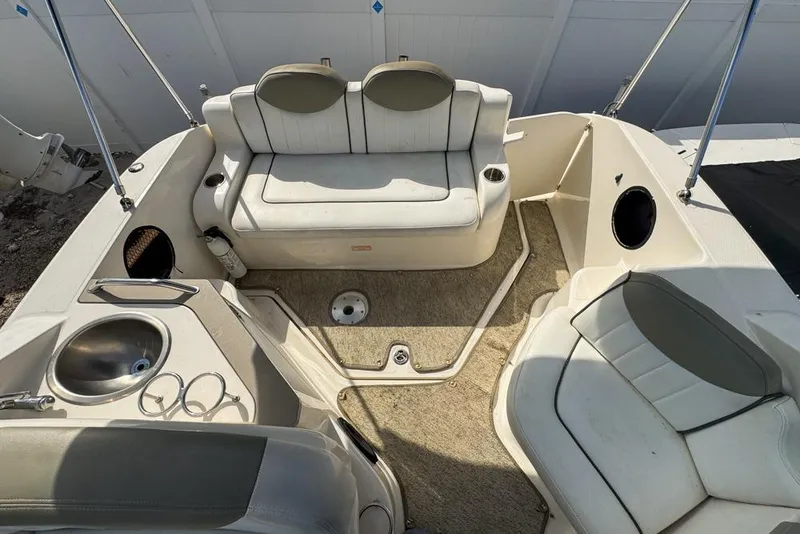 Slide: The Image of 2007 Sea Ray 240 Sundancer boat interior with seating and sink. - 111