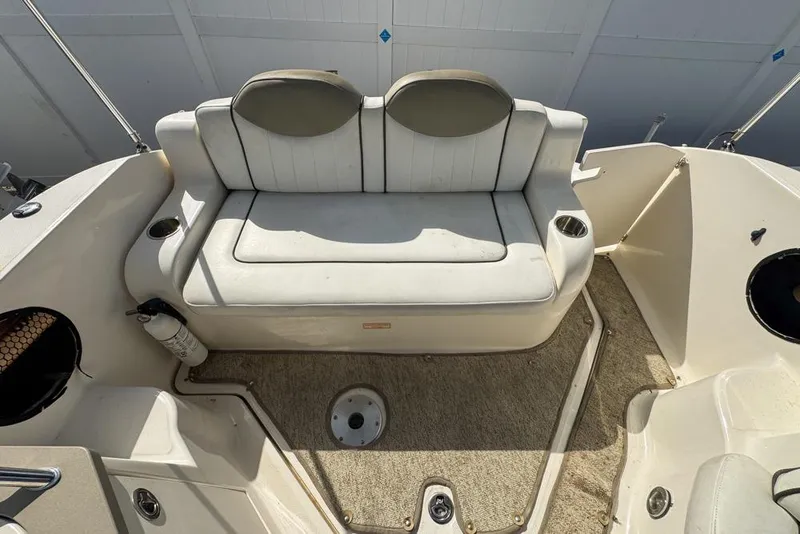Slide: The Image of 2007 Sea Ray 240 Sundancer boat interior with white seating and carpeted floor. - 114