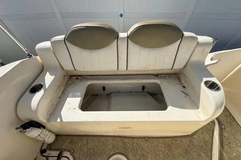 Slide: The Image of 2007 Sea Ray 240 Sundancer boat seat with storage compartment and cup holders. - 115