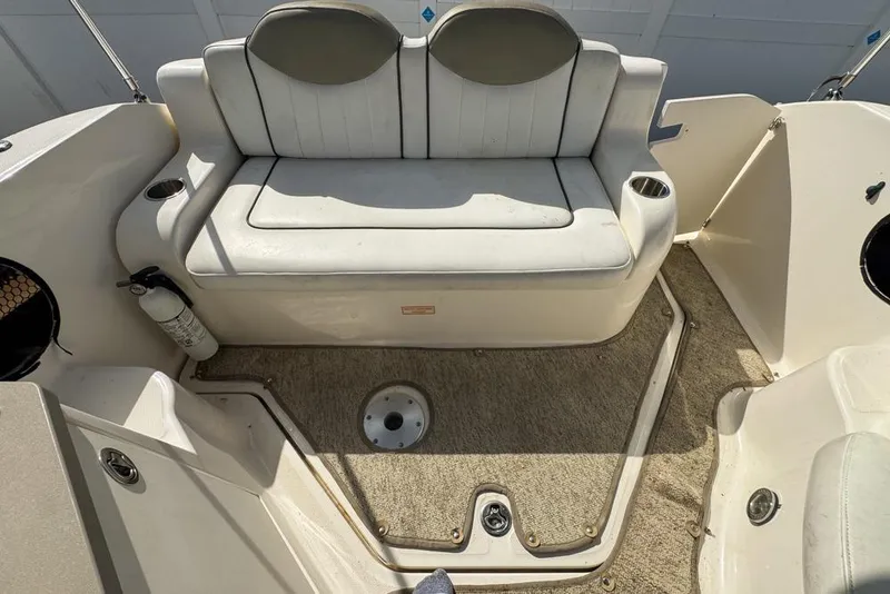 Slide: The Image of 2007 Sea Ray 240 Sundancer boat interior with cushioned seating and carpeted floor. - 116
