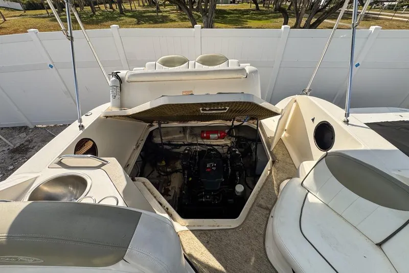 Slide: The Image of 2007 Sea Ray 240 Sundancer boat engine compartment with open hatch and seating area. - 117