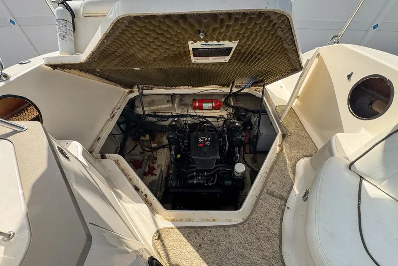 Slide: The Image of 2007 Sea Ray 240 Sundancer engine compartment with open hatch and visible fire extinguisher. - 118