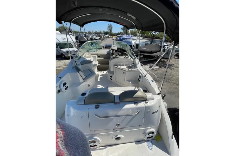Slide: The Image of 2007 Sea Ray 240 Sundancer boat on trailer, parked outdoors. - 12