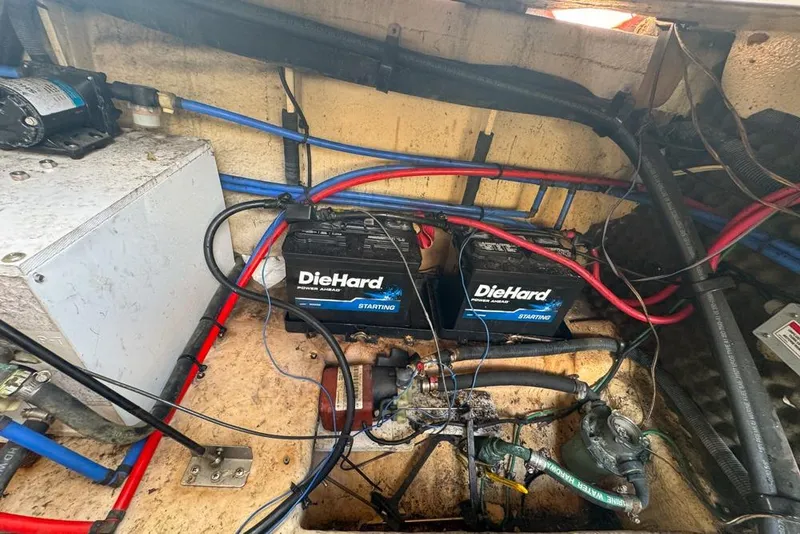 Slide: The Image of Engine compartment of a 2007 Sea Ray 240 Sundancer with DieHard batteries and wiring. - 123