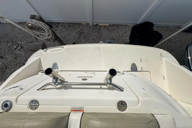 Slide: The Image of 2007 Sea Ray 240 Sundancer boat deck with rod holders and storage compartment. - 125
