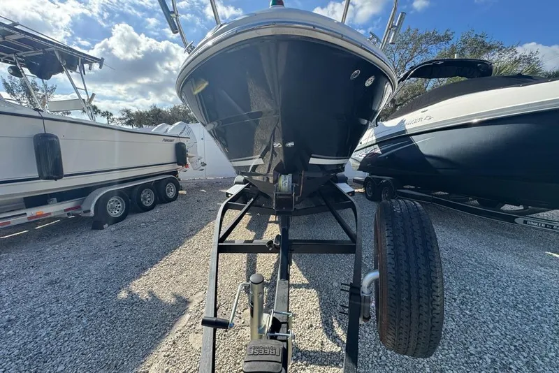 Slide: The Image of 2007 Sea Ray 240 Sundancer boat on trailer, parked outdoors under a blue sky. - 131