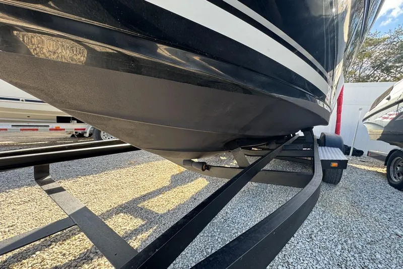 Slide: The Image of 2007 Sea Ray 240 Sundancer boat on trailer, parked on gravel. - 132