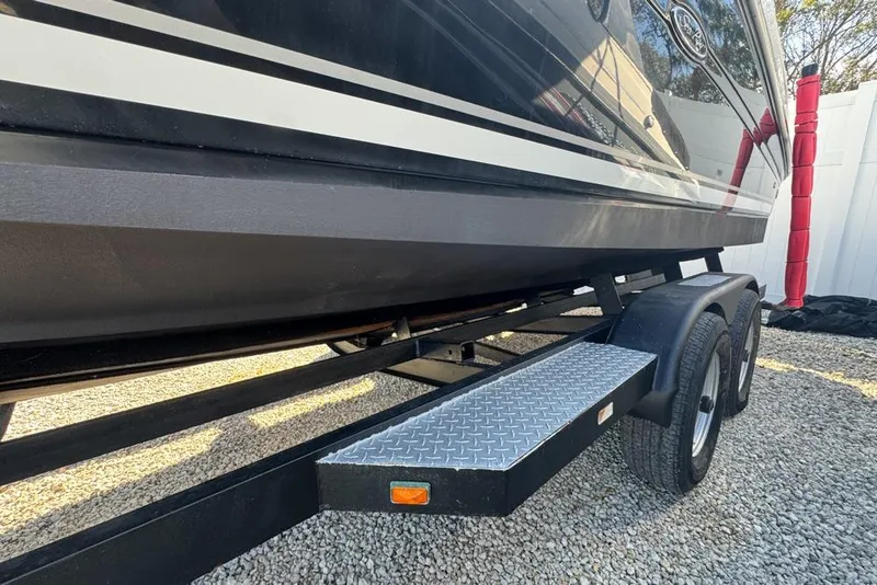 Slide: The Image of 2007 Sea Ray 240 Sundancer boat on trailer, side view, parked on gravel. - 133