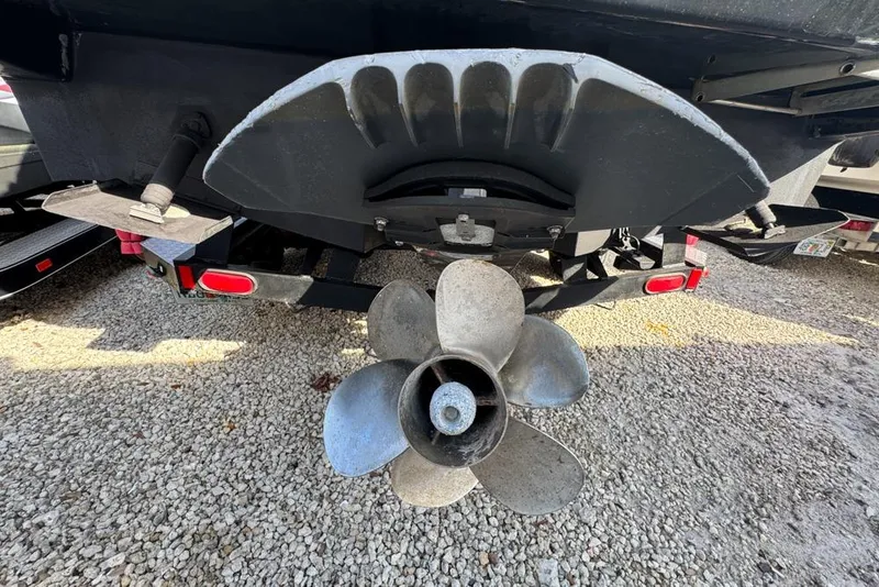 Slide: The Image of Rear view of 2007 Sea Ray 240 Sundancer boat propeller on gravel surface. - 138