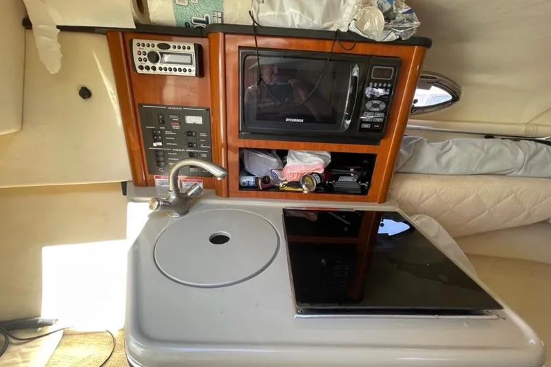 Slide: The Image of 2007 Sea Ray 240 Sundancer boat interior with seating and steering console. - 14