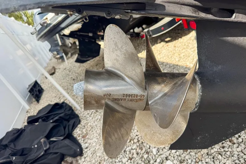 Slide: The Image of Close-up of a 2007 Sea Ray 240 Sundancer boat propeller on gravel surface. - 140