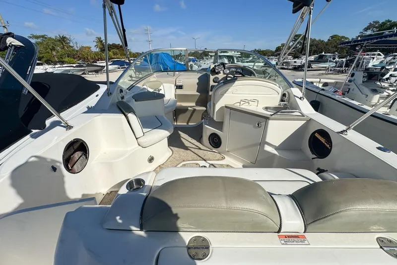 Slide: The Image of 2007 Sea Ray 240 Sundancer boat interior with seating and steering console. - 19