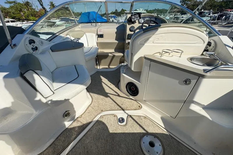 Slide: The Image of 2007 Sea Ray 240 Sundancer boat interior with seating, steering, and kitchenette area. - 20